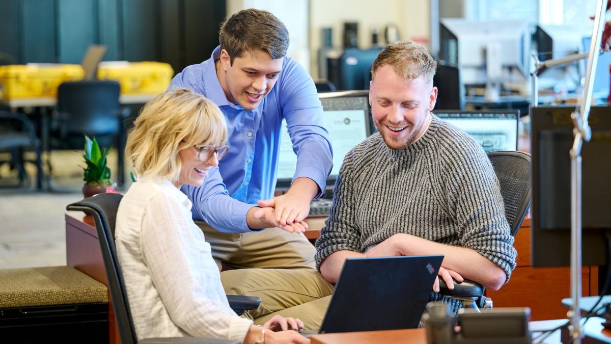 Tyler Schram working with other grad students at the IDL.