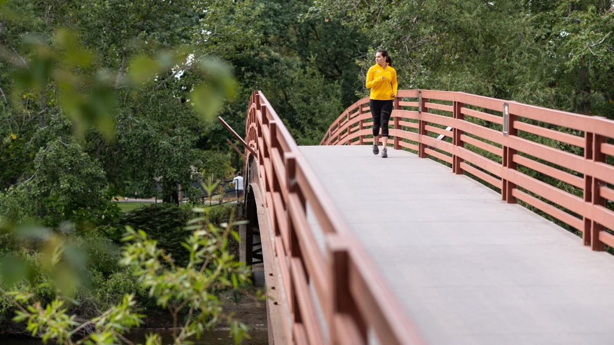 A person running across a bridge.